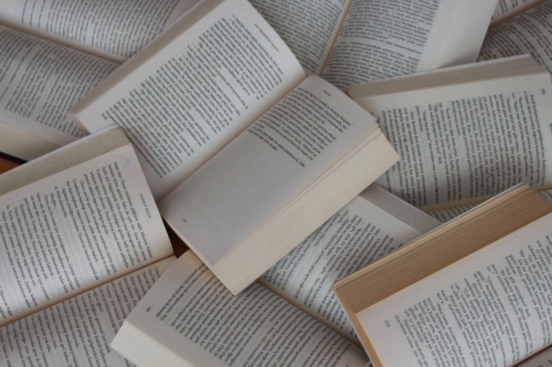 pile of open paperback books